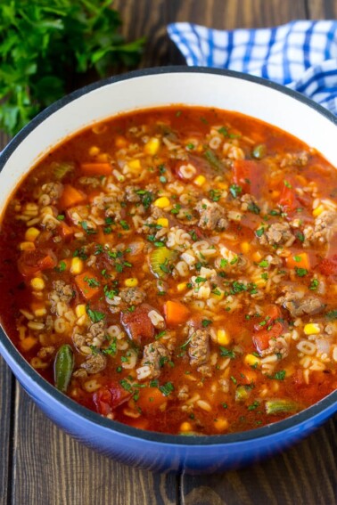A pot of alphabet soup with ground beef and vegetables.