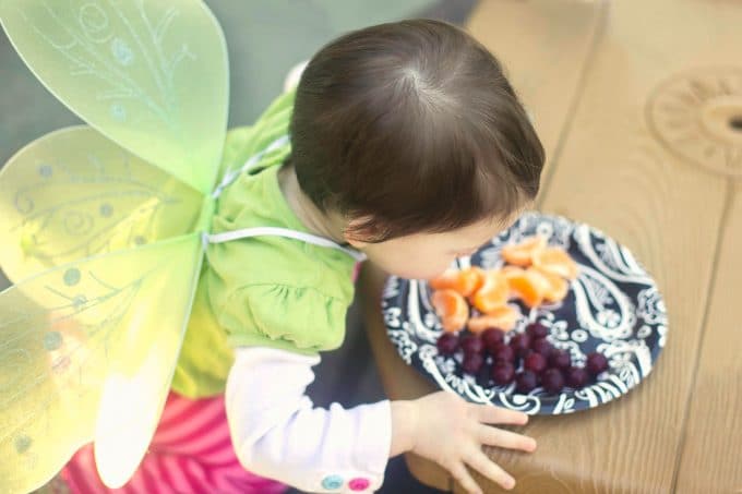 Baby eating fruit.