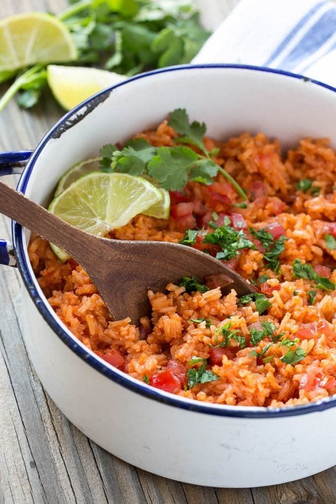 Mexican rice topped with cilantro and tomatoes.