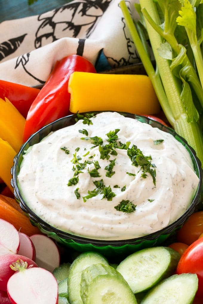 Homemade Ranch Dip Recipe | Homemade Ranch Powder | Homemade Ranch Dressing | Best Ranch Dip #ranch #dip #appetizer #snack #dinneratthezoo A bowl of dip topped with chopped parsley and surrounded by vegetables.