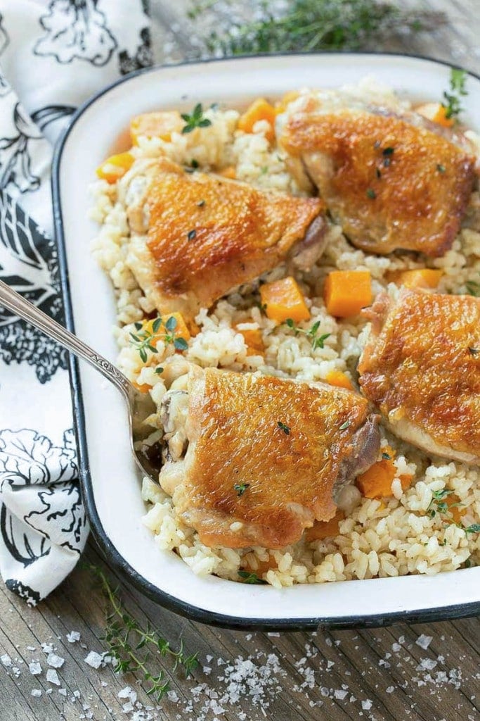 This One Pot Oven Chicken and Rice Bake combines chicken with creamy parmesan rice and butternut squash for a complete healthy meal with less dishes to clean.