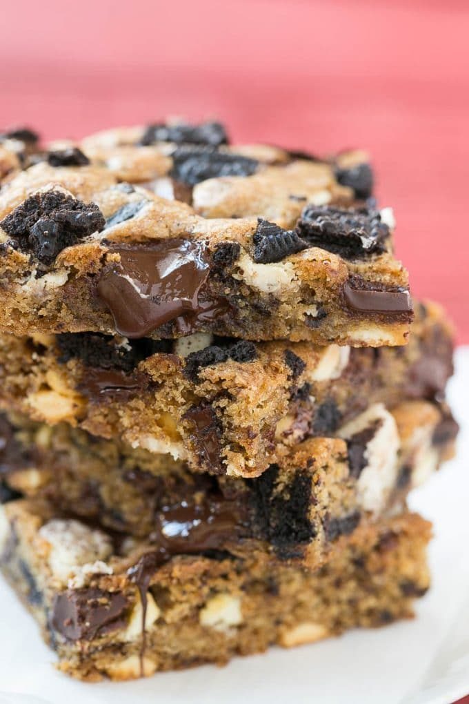 A stack of blondies filled with chocolate chunks and chopped Oreo cookies.