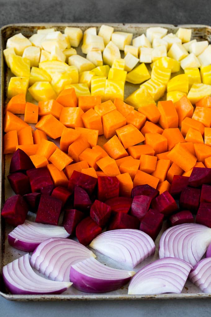 Onions, carrots, beets, parsnips and sweet potatoes on a sheet pan.