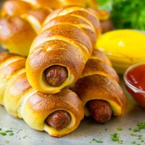 Bagel dogs served with ketchup and mustard on the side.