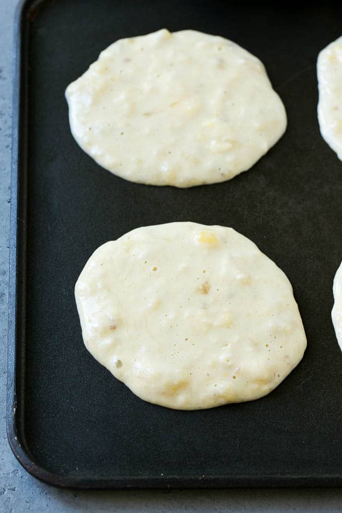 Banana pancakes on a skillet.