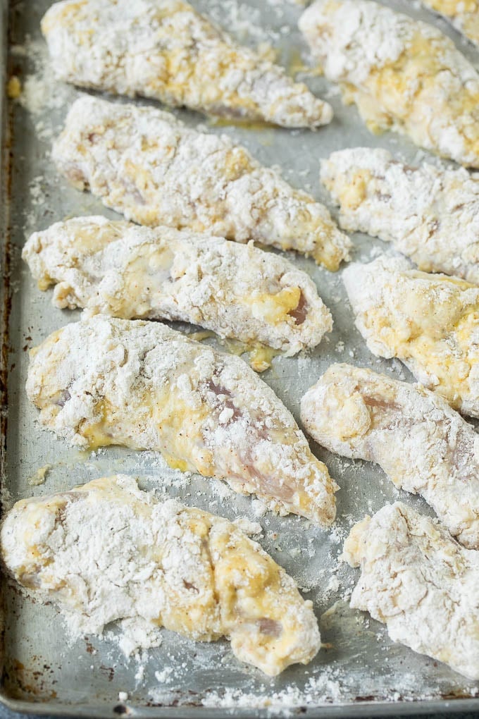 Breaded chicken fingers ready to go into the fryer.