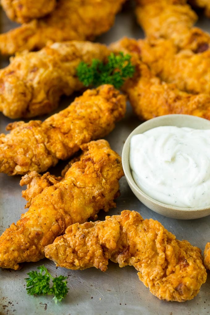 Crispy chicken tenders on a sheet pan.