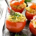 These baked stuffed tomatoes are full of spaghetti and topped with plenty of cheese. They're a fun and unique vegetarian side dish or main course!