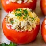 Stuffed Tomatoes with rice and sausage, topped with breadcrumbs and parsley.