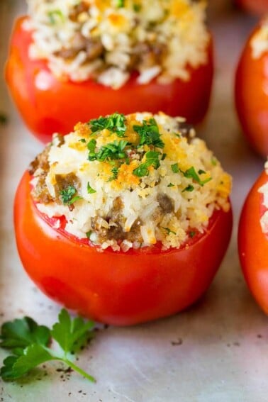 Stuffed Tomatoes with rice and sausage, topped with breadcrumbs and parsley.