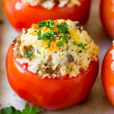 Stuffed Tomatoes with rice and sausage, topped with breadcrumbs and parsley.