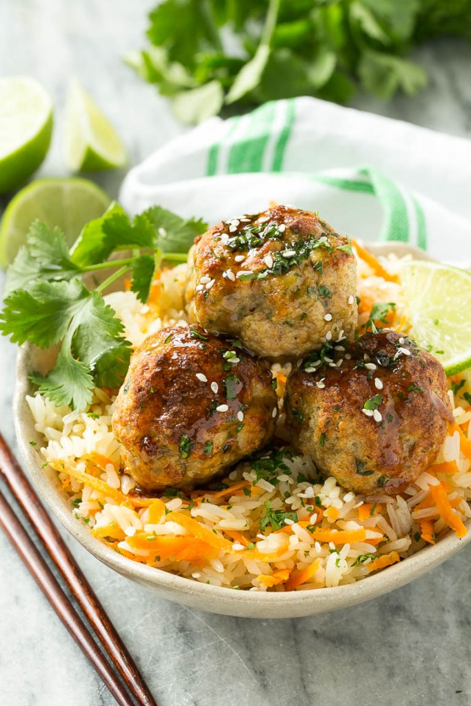This recipe for asian turkey meatballs involves light and tender meatballs that are seasoned with asian flavors, tossed in a honey garlic sauce and served over a colorful carrot rice. It's a quick and easy weeknight meal that the whole family will love!