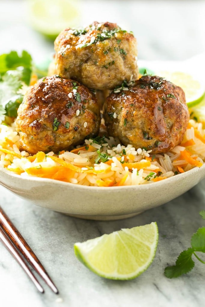 This recipe for asian turkey meatballs involves light and tender meatballs that are seasoned with asian flavors, tossed in a honey garlic sauce and served over a colorful carrot rice. It's a quick and easy weeknight meal that the whole family will love!