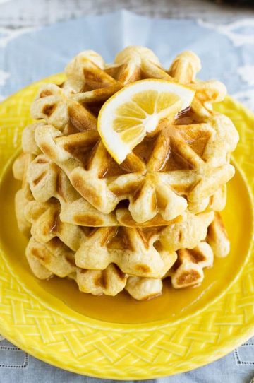 This recipe for lemon waffles made with sour cream are light and fluffy with the perfect amount of tang. Serve these waffles with maple syrup or lemon curd for the perfect weekend breakfast!