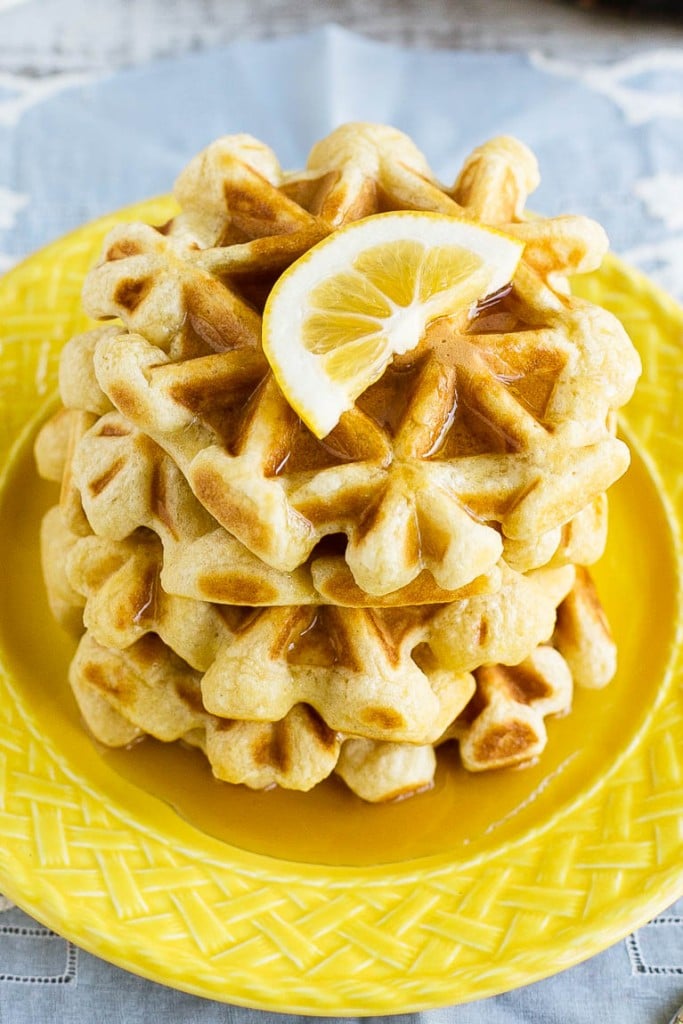 This recipe for lemon waffles made with sour cream are light and fluffy with the perfect amount of tang. Serve these waffles with maple syrup or lemon curd for the perfect weekend breakfast!