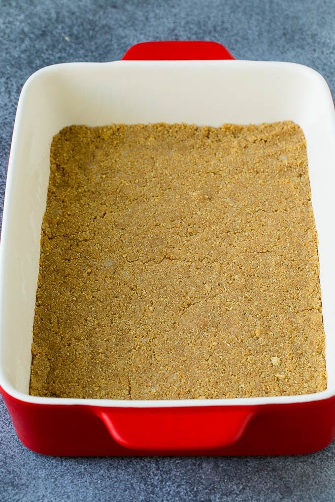 A graham cracker crust in a rectangular baking dish.