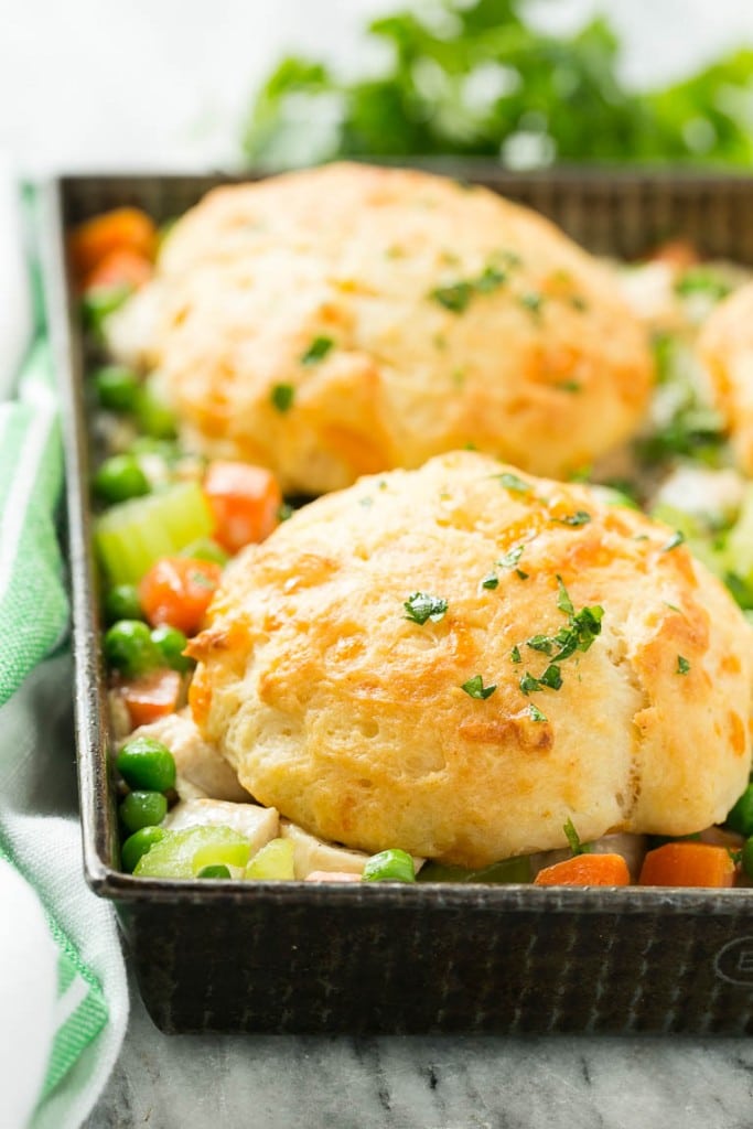 This recipe for biscuit chicken pot pie is a creamy mixture of seasoned chicken, vegetables and herbs that's been topped with flaky cheddar biscuits and baked to perfection.