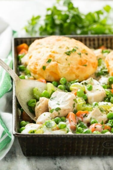 This recipe for biscuit chicken pot pie is a creamy mixture of seasoned chicken, vegetables and herbs that's been topped with flaky cheddar biscuits and baked to perfection.