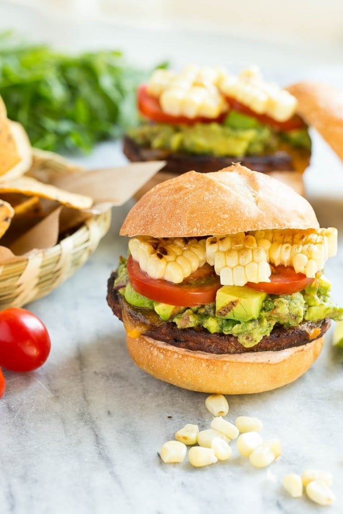 This recipe is for a black bean veggie burger with a Mexican twist! The veggie patty is layered with southwestern sauce, grilled corn, guacamole, cheese and tomatoes to create a hearty vegetarian sandwich.