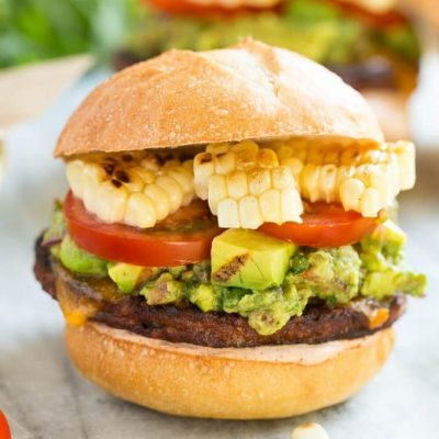 This recipe is for a black bean veggie burger with a Mexican twist! The veggie patty is layered with southwestern sauce, grilled corn, guacamole, cheese and tomatoes to create a hearty vegetarian sandwich.