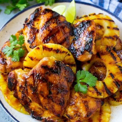 A plate of Hawaiian chicken with grilled pineapple.