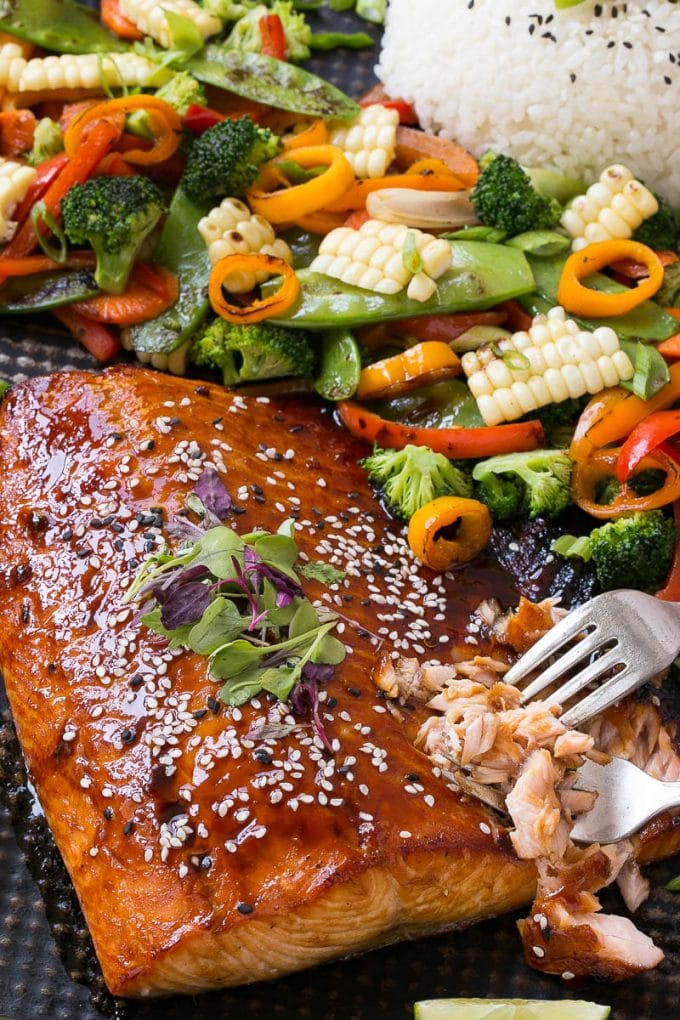 Asian salmon on a sheet pan with vegetables and rice.