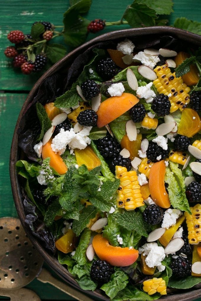 Blackberry salad with apricots, corn, feta cheese and almonds.