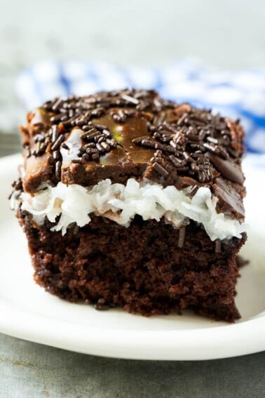 This chocolate coconut cake recipe is a rich chocolate cake topped with a creamy coconut marshmallow sauce and finished off with a layer of chocolate frosting.