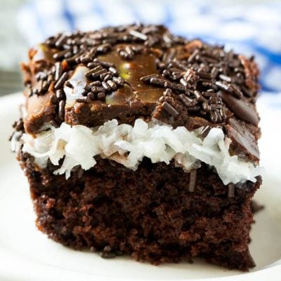 This chocolate coconut cake recipe is a rich chocolate cake topped with a creamy coconut marshmallow sauce and finished off with a layer of chocolate frosting.