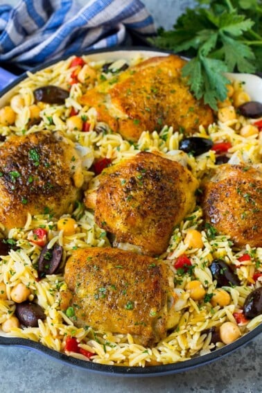 A pan of Mediterranean chicken with orzo, chickpeas and vegetables.