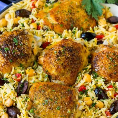 A pan of Mediterranean chicken with orzo, chickpeas and vegetables.