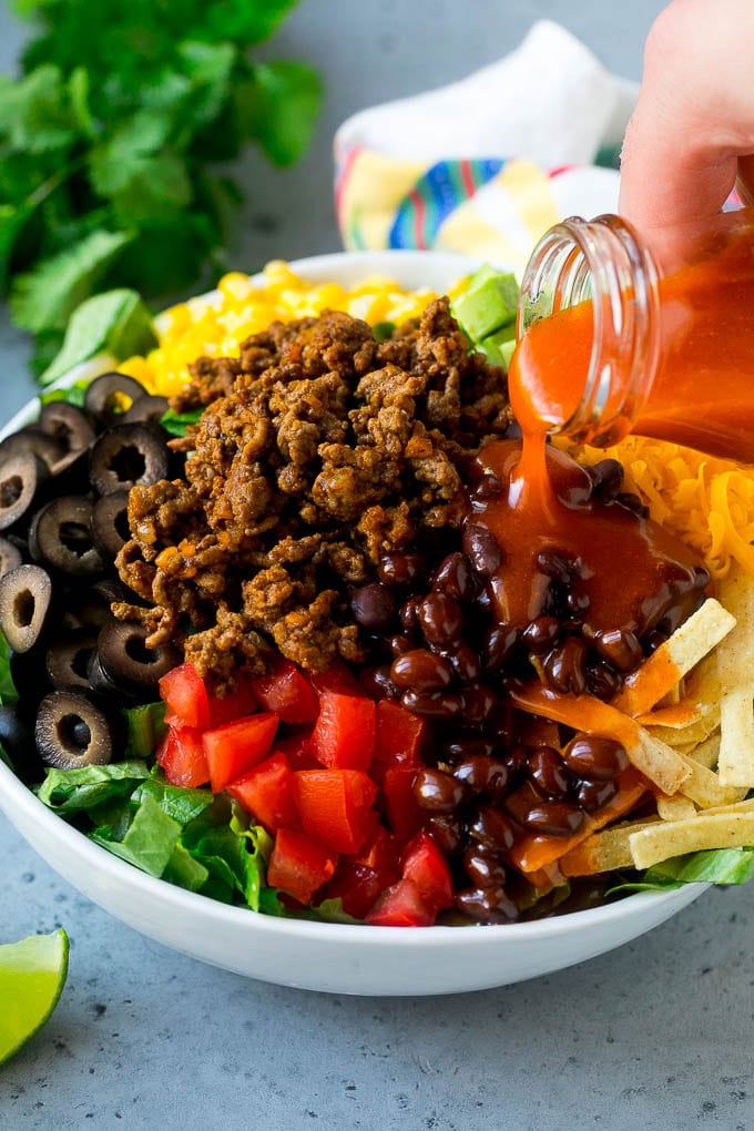 Catalina dressing being poured over taco salad.