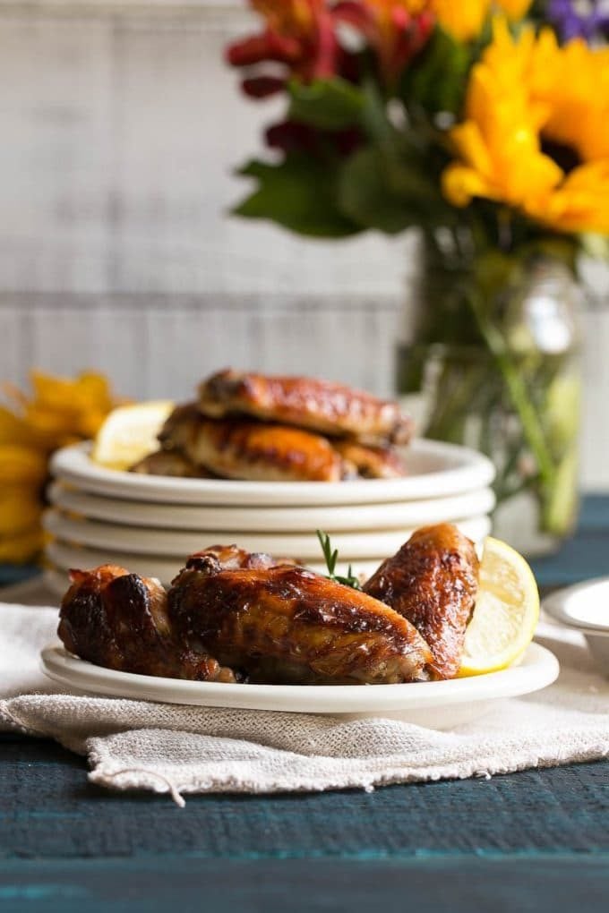 Lemon chicken wings on small plates.