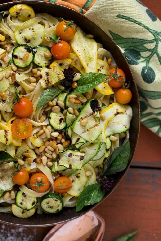 Fettuccine Alfredo with grilled zucchini, cherry tomatoes and pine nuts.