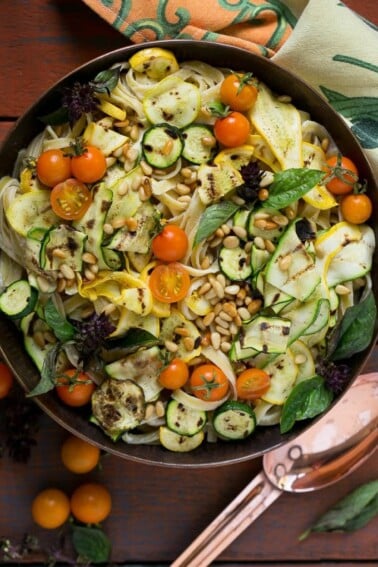 This zucchini fettuccine alfredo features a healthier remake of the classic sauce (no cream!) with the addition of grilled zucchini, cherry tomatoes and pine nuts.