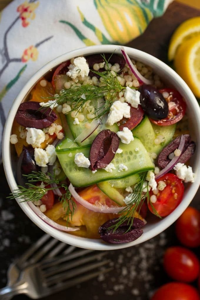 Israeli couscous with cucumber ribbons, heirloom tomatoes and olives.