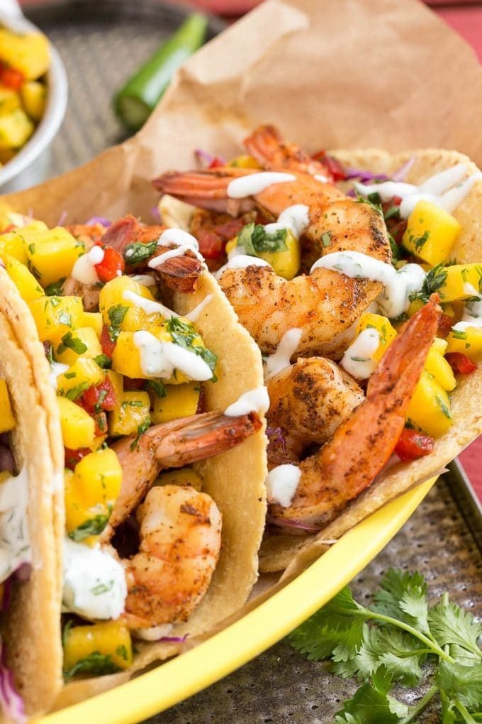 Shrimp tacos with mango salsa in a basket.