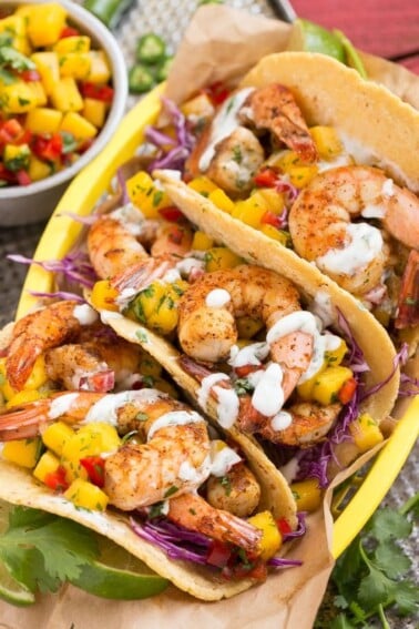 Shrimp tacos with sweet and tangy mango salsa and creamy cilantro lime sauce.