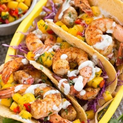 Shrimp tacos with sweet and tangy mango salsa and creamy cilantro lime sauce.