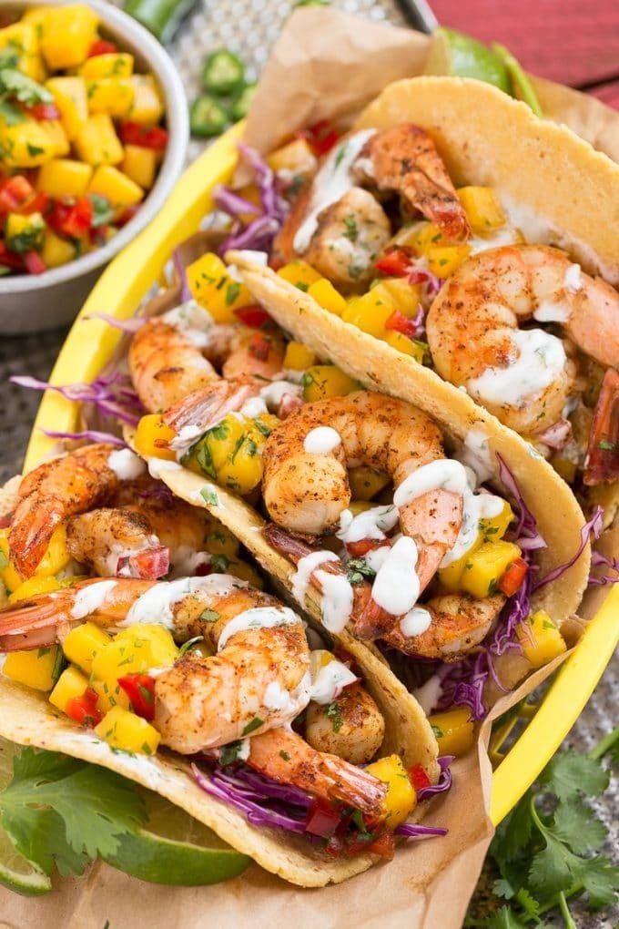 Shrimp tacos with fresh mango salsa and creamy sauce.