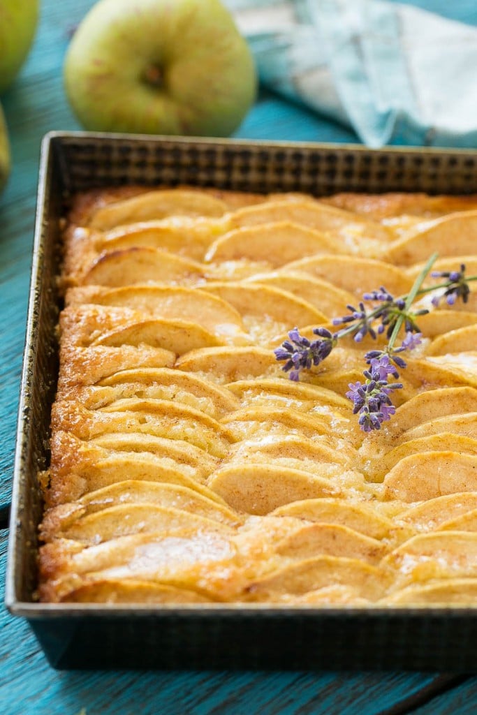 A recipe for a buttery cake full of cinnamon sugar apples and topped with honey.