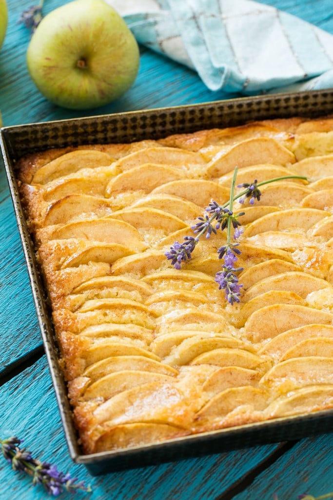A recipe for a buttery cake full of cinnamon sugar apples and topped with honey.