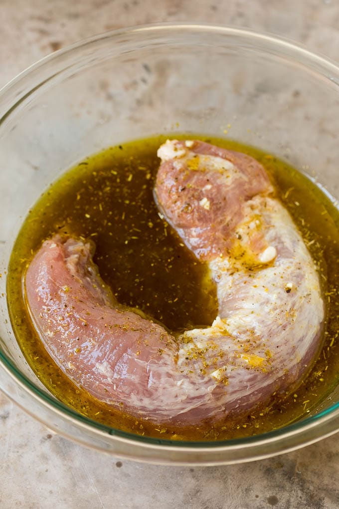 Pork tenderloin in a bowl of marinade