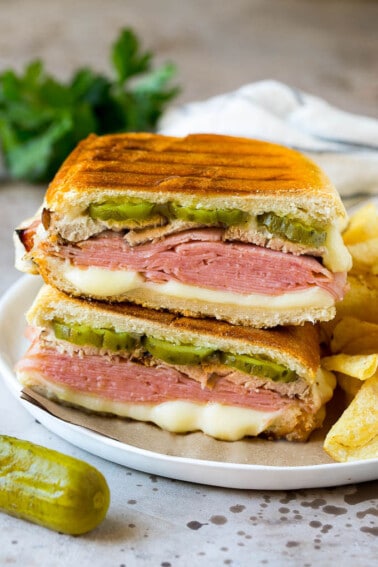 A pressed Cuban sandwich with layers of ham, cheese and pickles.