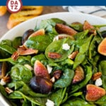 This fig salad is fresh figs, spinach, goat cheese and candied pecans, all tossed together in a homemade balsamic vinaigrette.