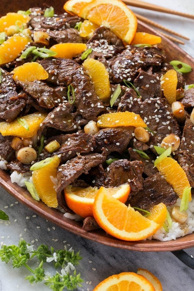 Orange beef topped with green onions and sesame seeds.