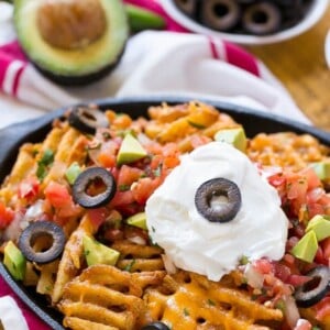 Waffle fries are smothered in nacho toppings for a fun and delicious snack. #FarmtoFlavor Ad