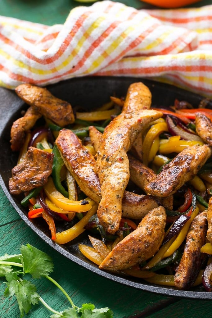 These fajita chicken cheesesteak sandwiches are full of spiced chicken, peppers and lots of cheese, all on a toasted roll.