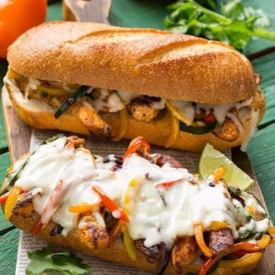 These fajita chicken cheesesteak sandwiches are full of spiced chicken, peppers and lots of cheese, all on a toasted roll. AD