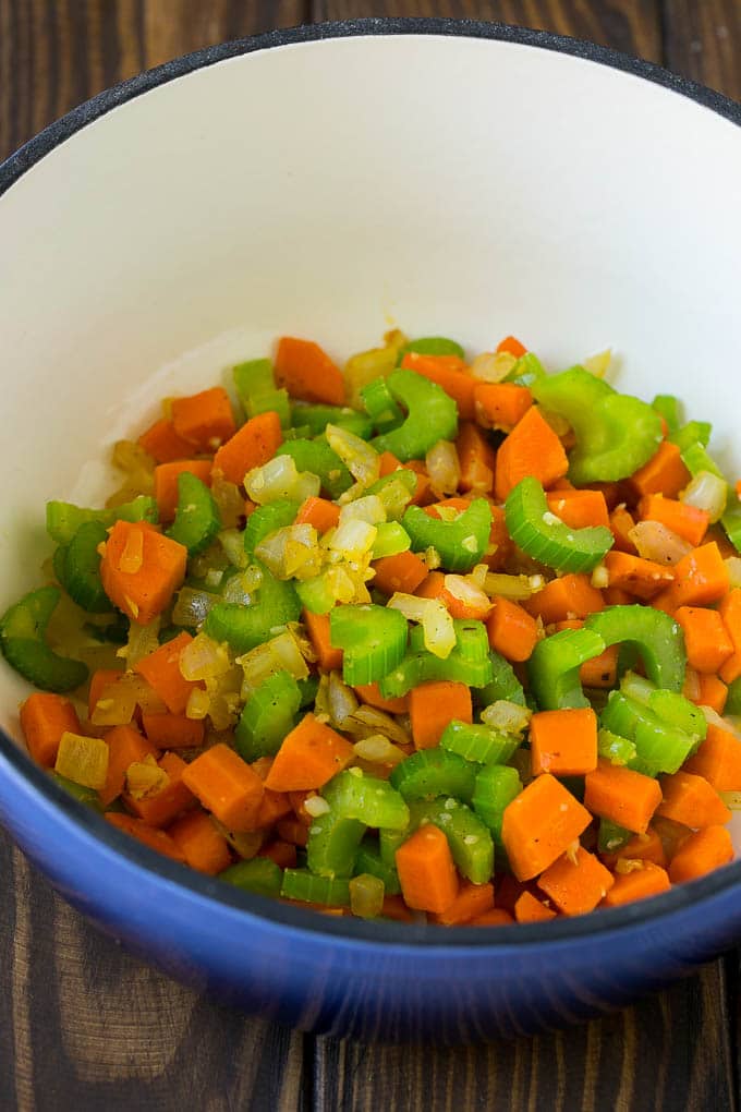 Carrots, onion and celery in a soup pot.